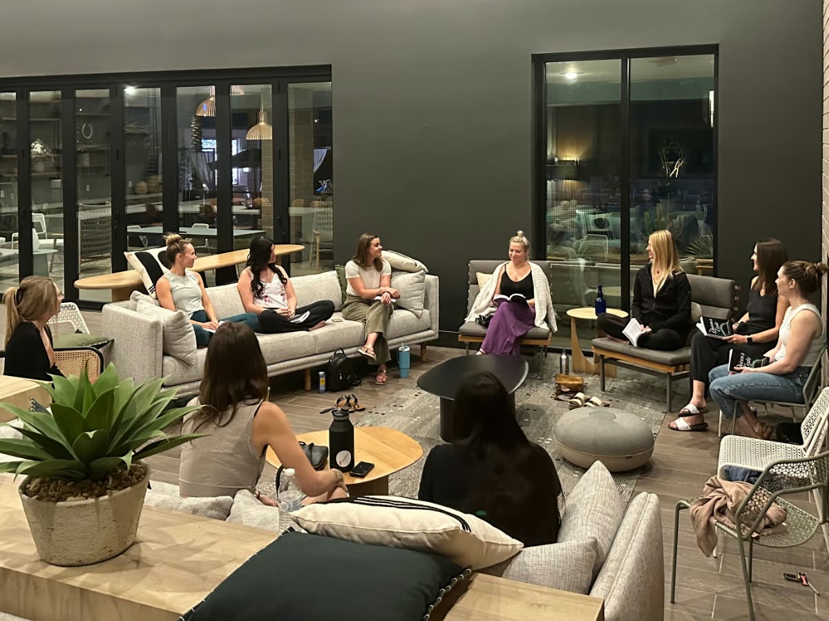 A circle of women talking in a lounge in the evening